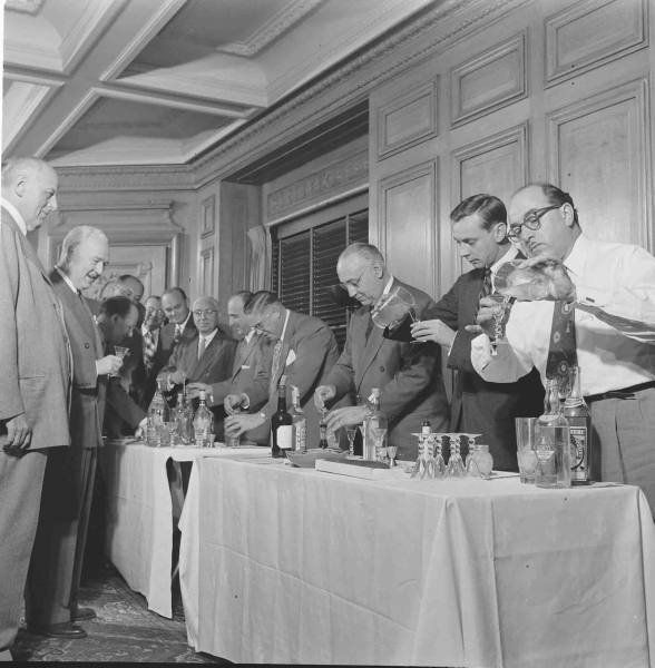 Vintage men making martinis cocktails placed on the table.