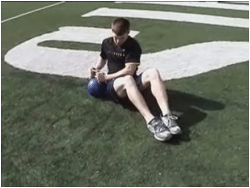 Man doing kettlebell exercise in ground.