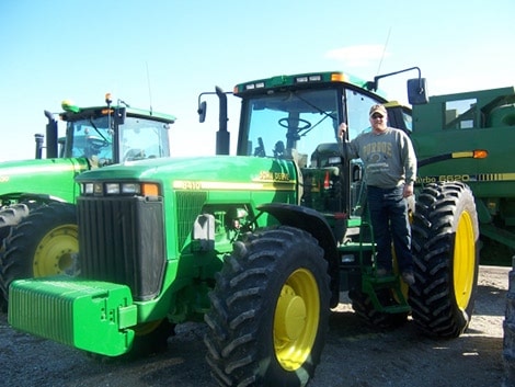 Brian Bradley farmer with john deere tractor.