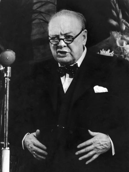 Winston churchill giving instense speech with glasses.