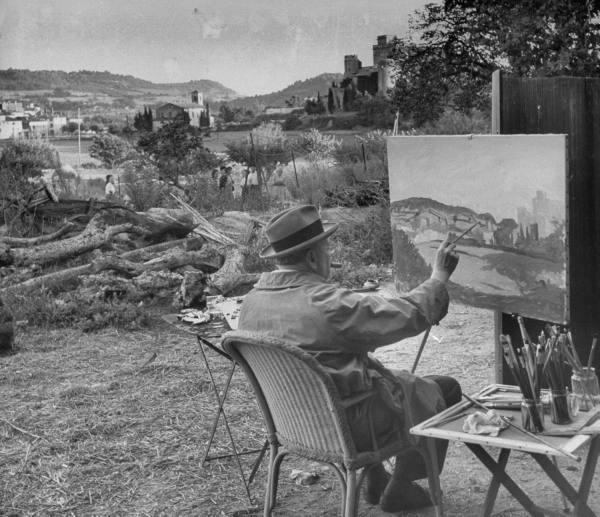 Winston Churchill hobby painting outside with cigar.