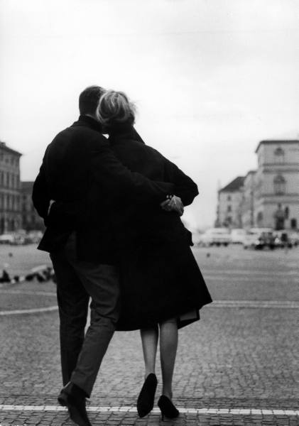 Vintage couple romantic hugging outside cool weather.