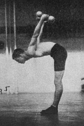 Vintage man doing dumbbell workout in gym.