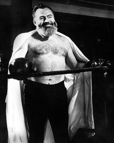 Ernest Hemingway wearing boxing gloves for practice.