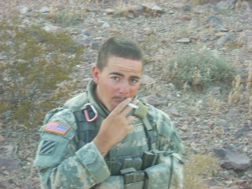 American soldier posing while smoking.