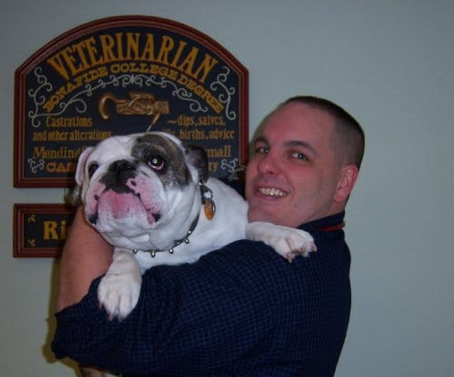 Richard Mcaroy posing with his bulldog.