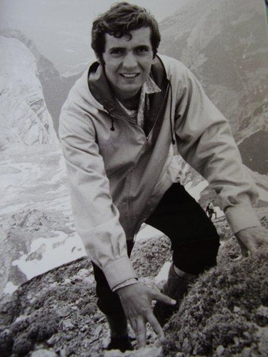 Vintage man posing while climbing on the rock.