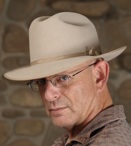 Dean Zatkowsky ghostwriter posing while wearing cowboy's hat.