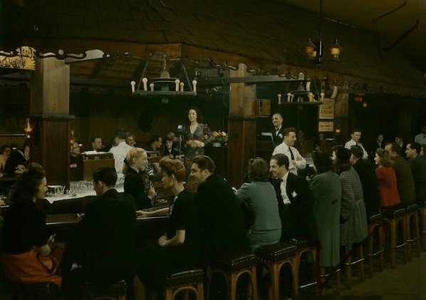 Vintage bar crowded with people.