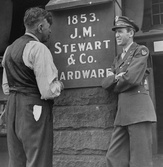 Jimmy Stewart talking to his father while wearing uniform.