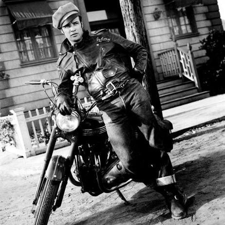 Vintage Marlon Brando giving heroic pose with motorcycle.
