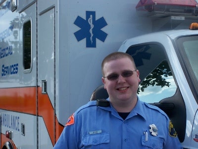 Man standing in front of ambulance.