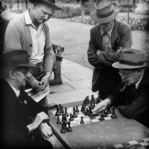 Vintage men playing chess in the park.