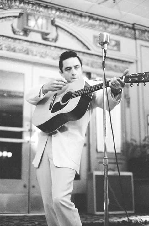 Vintage Johnny Cash playing guitar.