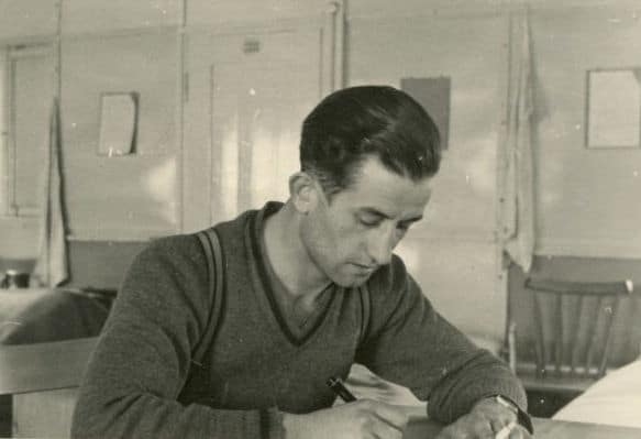 Vintage man writing a letter at desk.