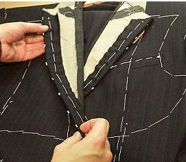 Man seeing suit stitching.