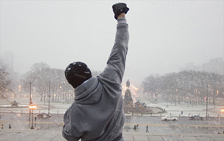 Man raising his hand in snow falling.