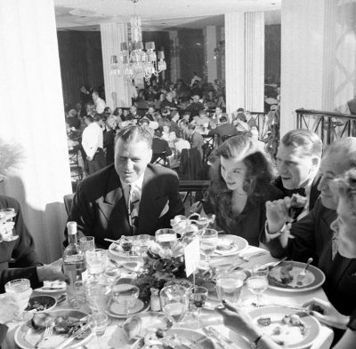 Vintage people enjoying dinner in restaurant.