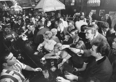 Vintage people enjoy drinking in bar.