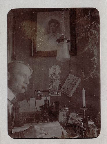 Vintage man thinking at desk cigar in mouth.