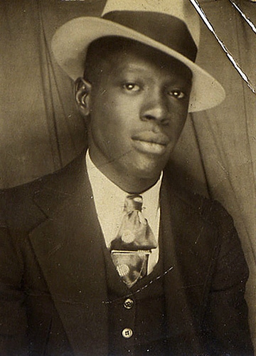 Vintage black American man wearing hat and suit.