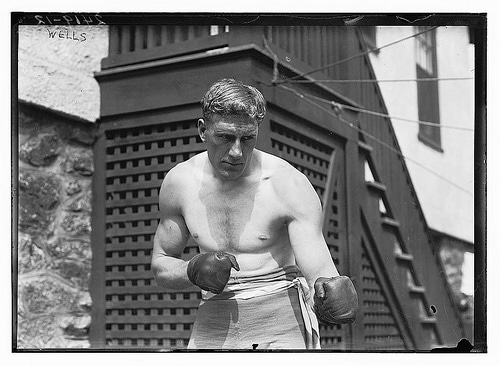 Vintage boxer shirtless with gloves boxing posing.