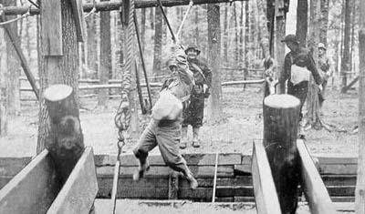 Vintage men on a ropes course.