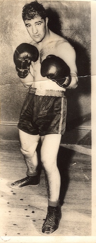 Rocky Marciano classic boxing pose in gloves and shorts.