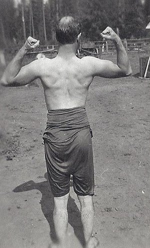 Vintage man posing flexing balding.