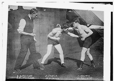 Vintage young men photo while boxing from early 20th century.