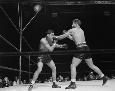 Vintage boxing match of Joe Louis in the ring.