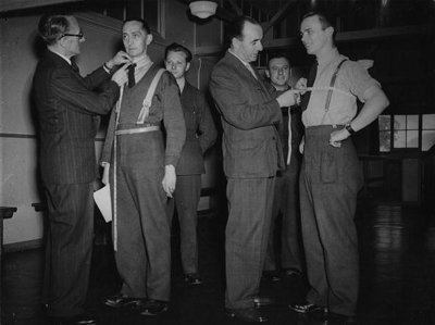 Vintage tailors measuring the men's chest and neck.