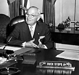 Harry Truman president bucking in his office.