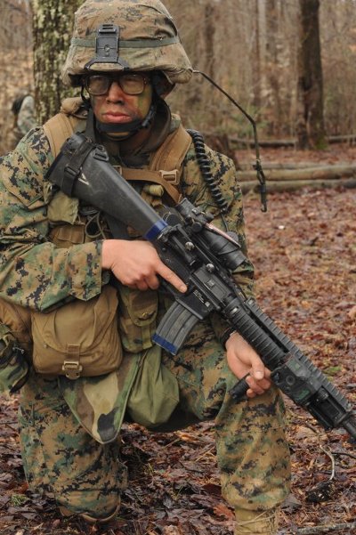 Ryan Kwan the marine corps officer wearing glasses in camouflage.