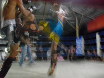 Blurry fighters in ring illustration.
