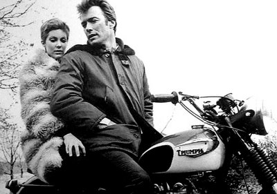 Clint Eastwood sitting on motorcycle with his wife.