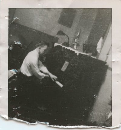Vintage man playing piano in the room. 