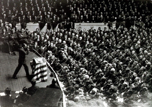 Photographer taking picture of spectators from stage.