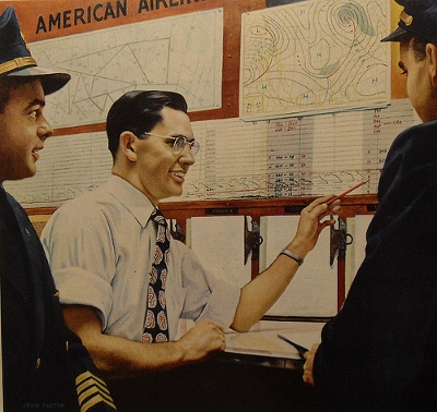 American airlines officer explaining maps to pilots. 