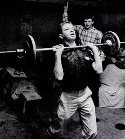 Vintage man lifting barbell weight. 