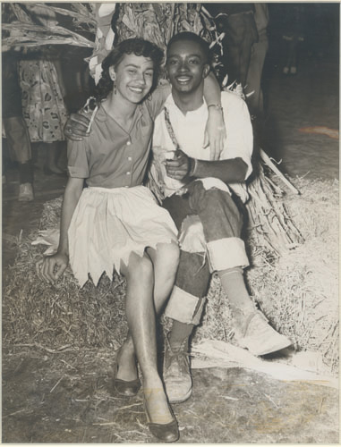 Vintage couple sitting on hay. 