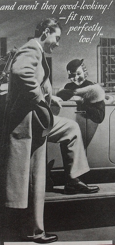 Vintage man showing his shoes to woman sitting in car. 