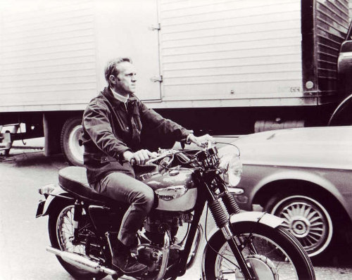 Steve Mcqueen riding on motorcycle. 