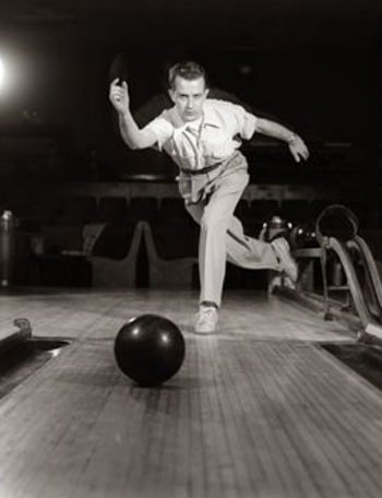 Vintage man playing bowling ball.