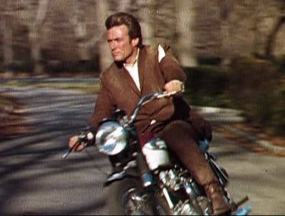 Clint Eastwood riding on motorcycle. 