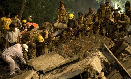 Firefighters rescuers lifting rubble for searching people. 