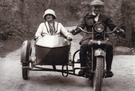 Vintage couple riding on motorcycle.