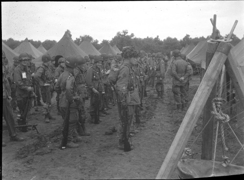 Vintage military men standing in ranks field.