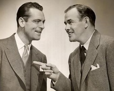 Vintage two businessmen talking conversation pointing.