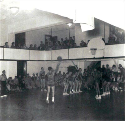 Vintage basketball game and man shooting free throw.